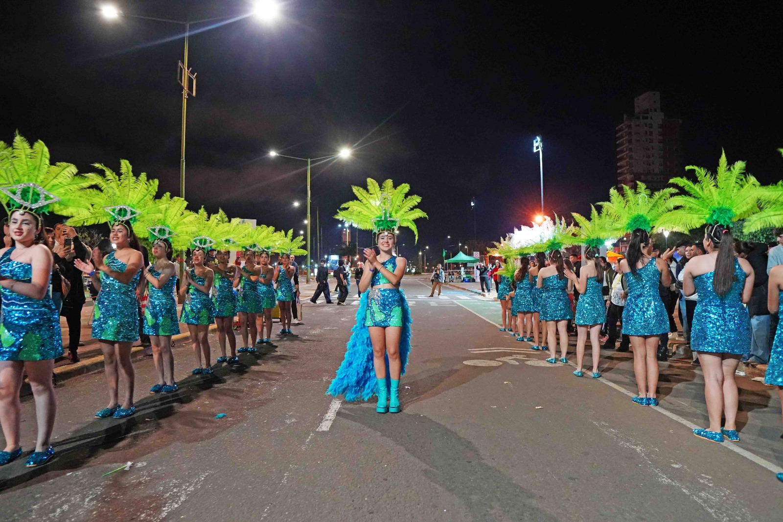 Grupo de estudiantes celebrando en la calle, luces brillantes y confeti
